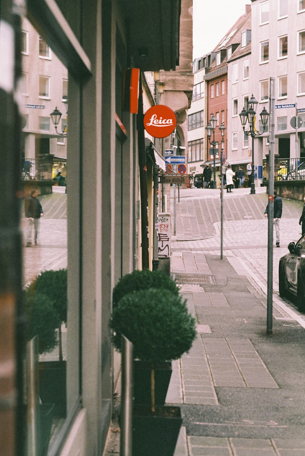 a view of a street with cars parked on the side of it