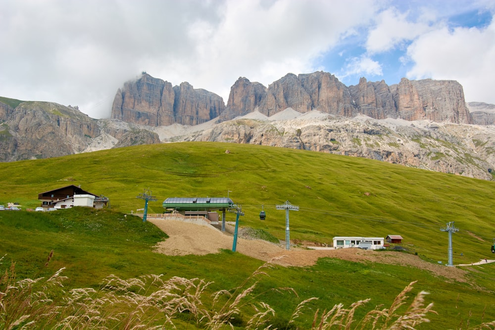 a grassy hill with a small house on top of it