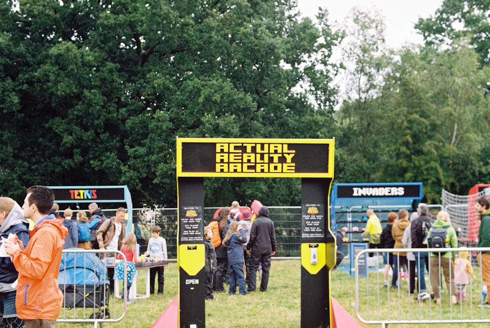 a group of people standing in front of a sign