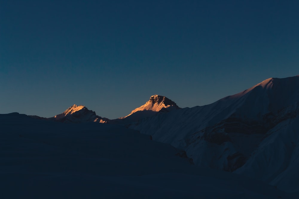 a view of the top of a mountain at sunset