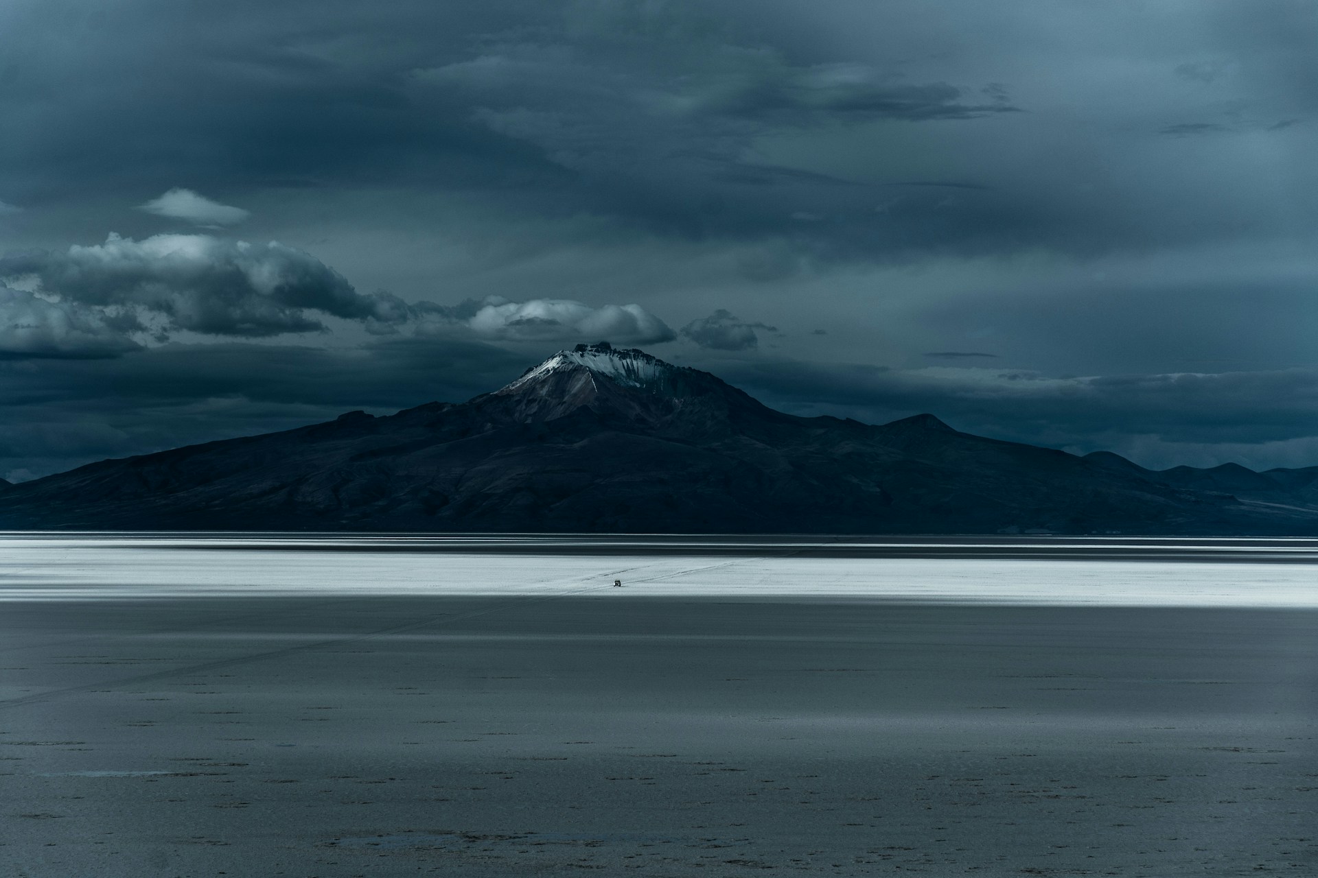 a large body of water with a mountain in the background