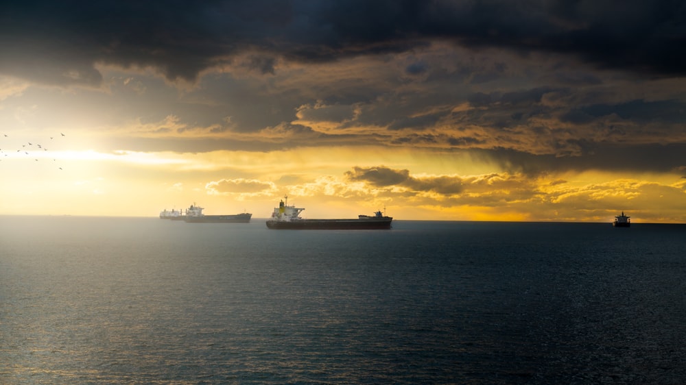 a group of ships floating on top of a large body of water