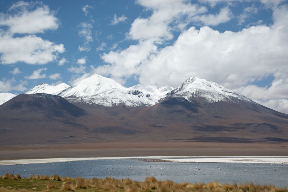 a mountain range with a body of water in the foreground