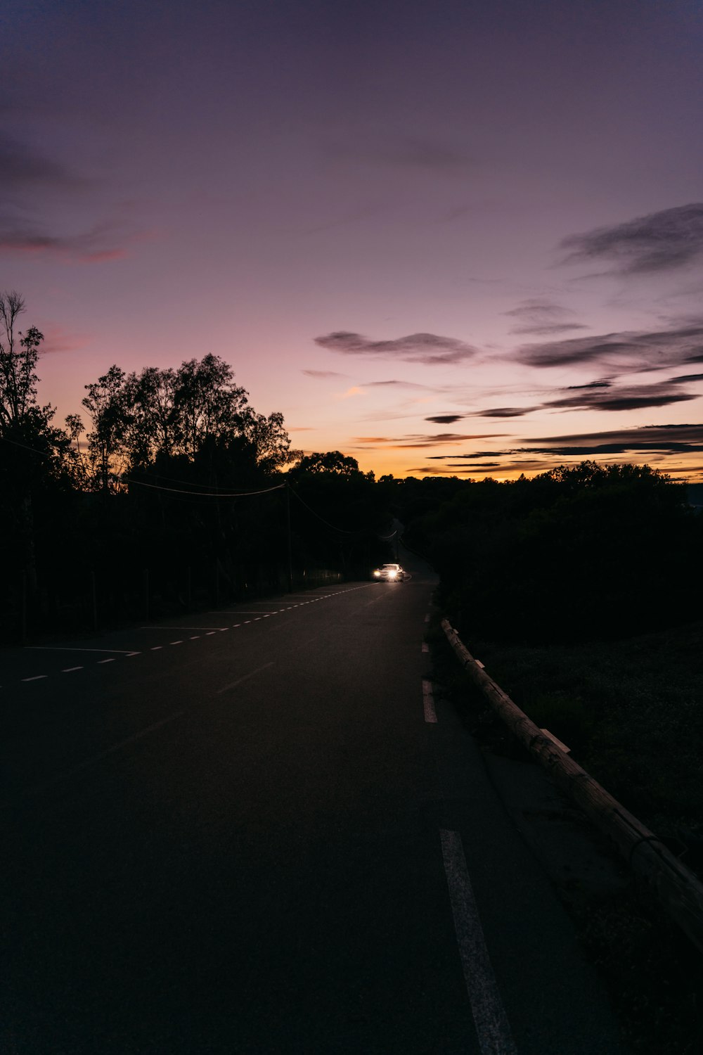 a car driving down a road at night