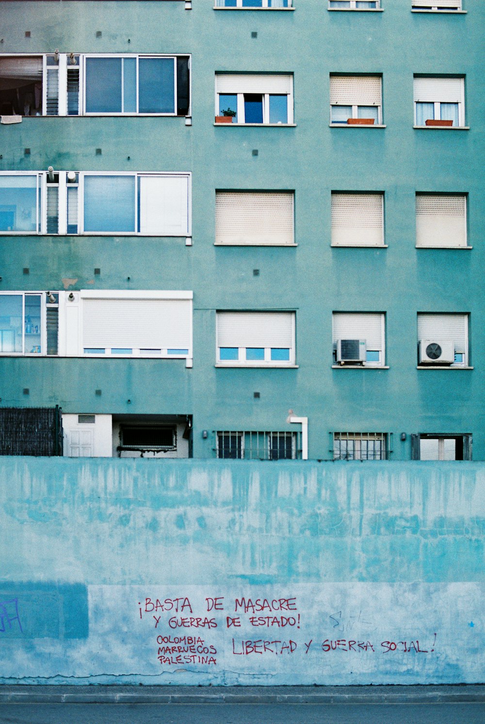 a man riding a skateboard past a tall building