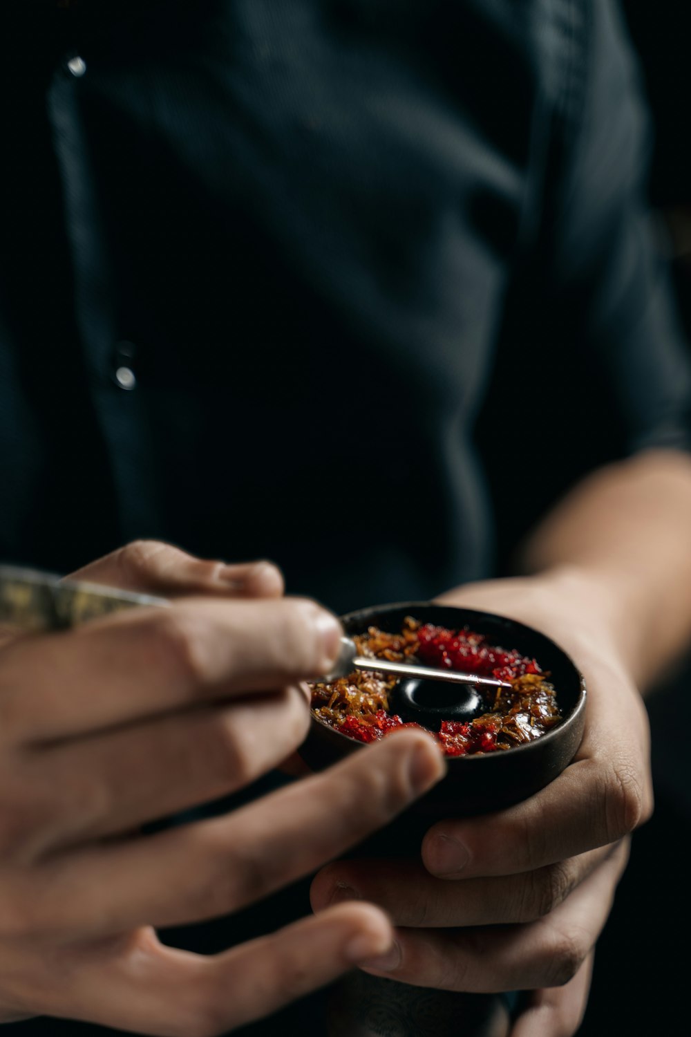 a person holding a bowl of food in their hands