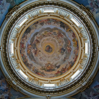 the ceiling of a building with a painting on it