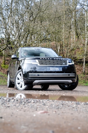 a black range rover parked on the side of a road