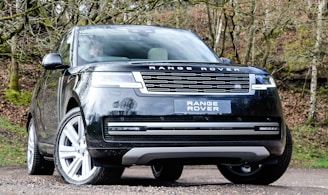 a black range rover parked on the side of a road