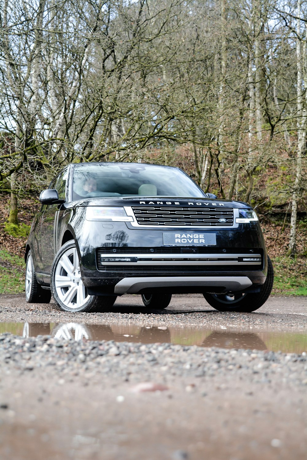 a black range rover parked on the side of a road