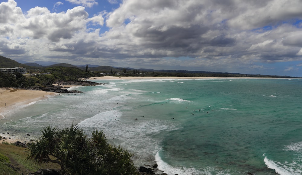 uma vista de uma praia com pessoas nadando na água