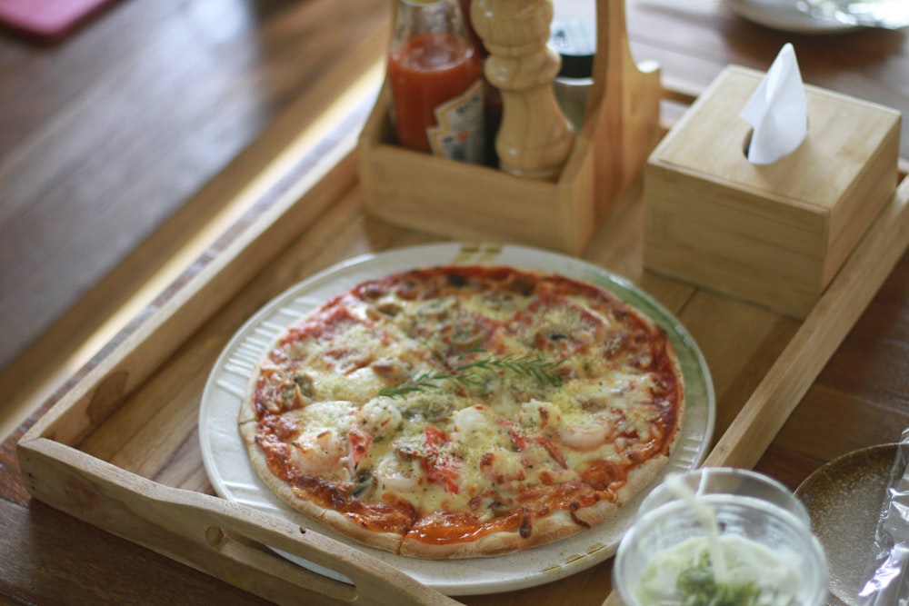a pizza sitting on top of a wooden tray