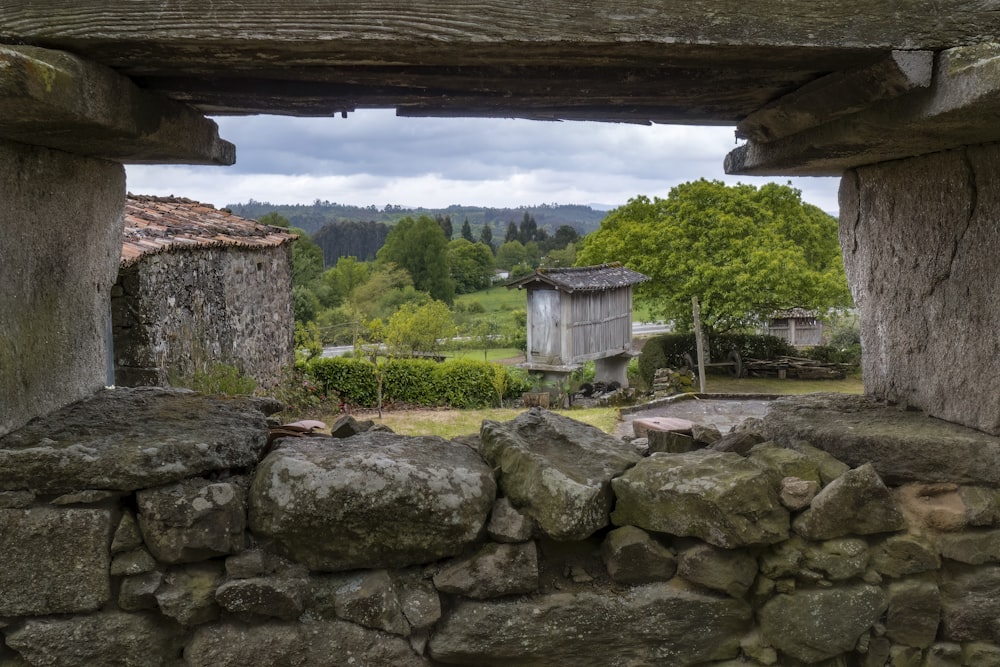 a stone wall with a window in the middle of it