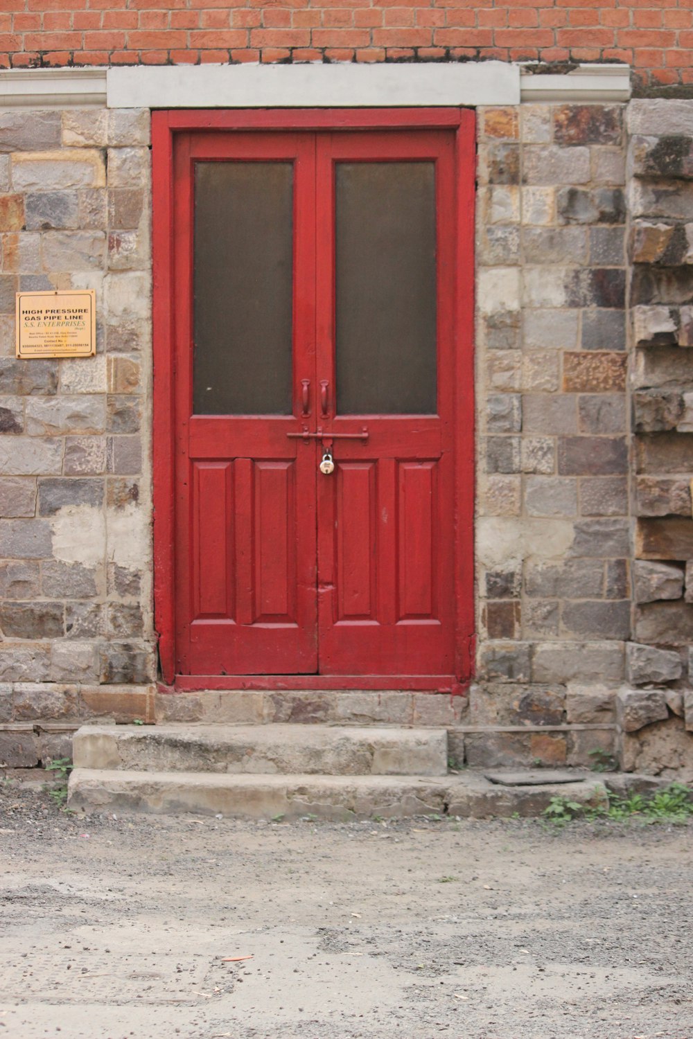 a fire hydrant sitting in front of a red door