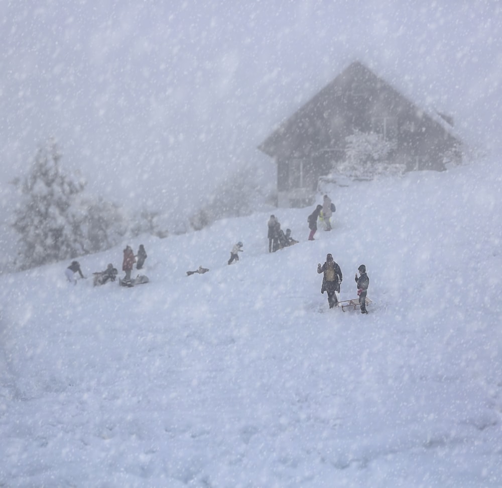 a group of people standing on top of a snow covered slope