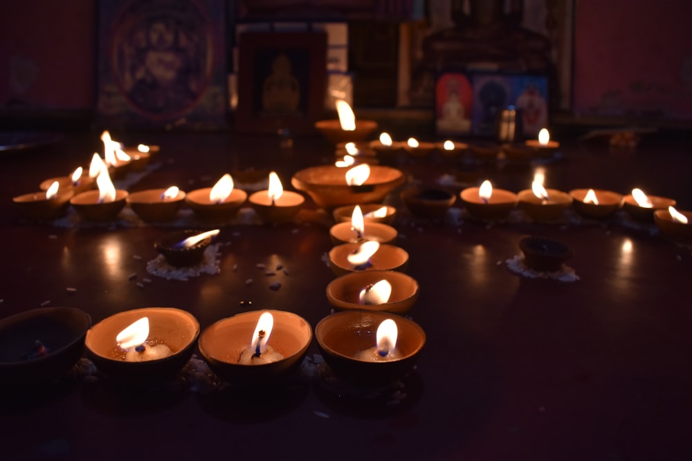 a group of lit candles sitting on top of a table