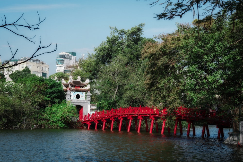 a red bridge over a body of water