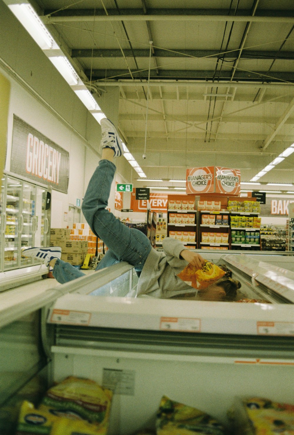 a person is in a grocery store with their feet up