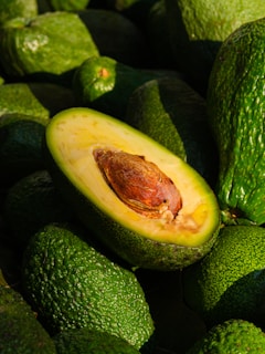 a pile of green avocados sitting on top of each other