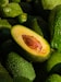 a pile of green avocados sitting on top of each other