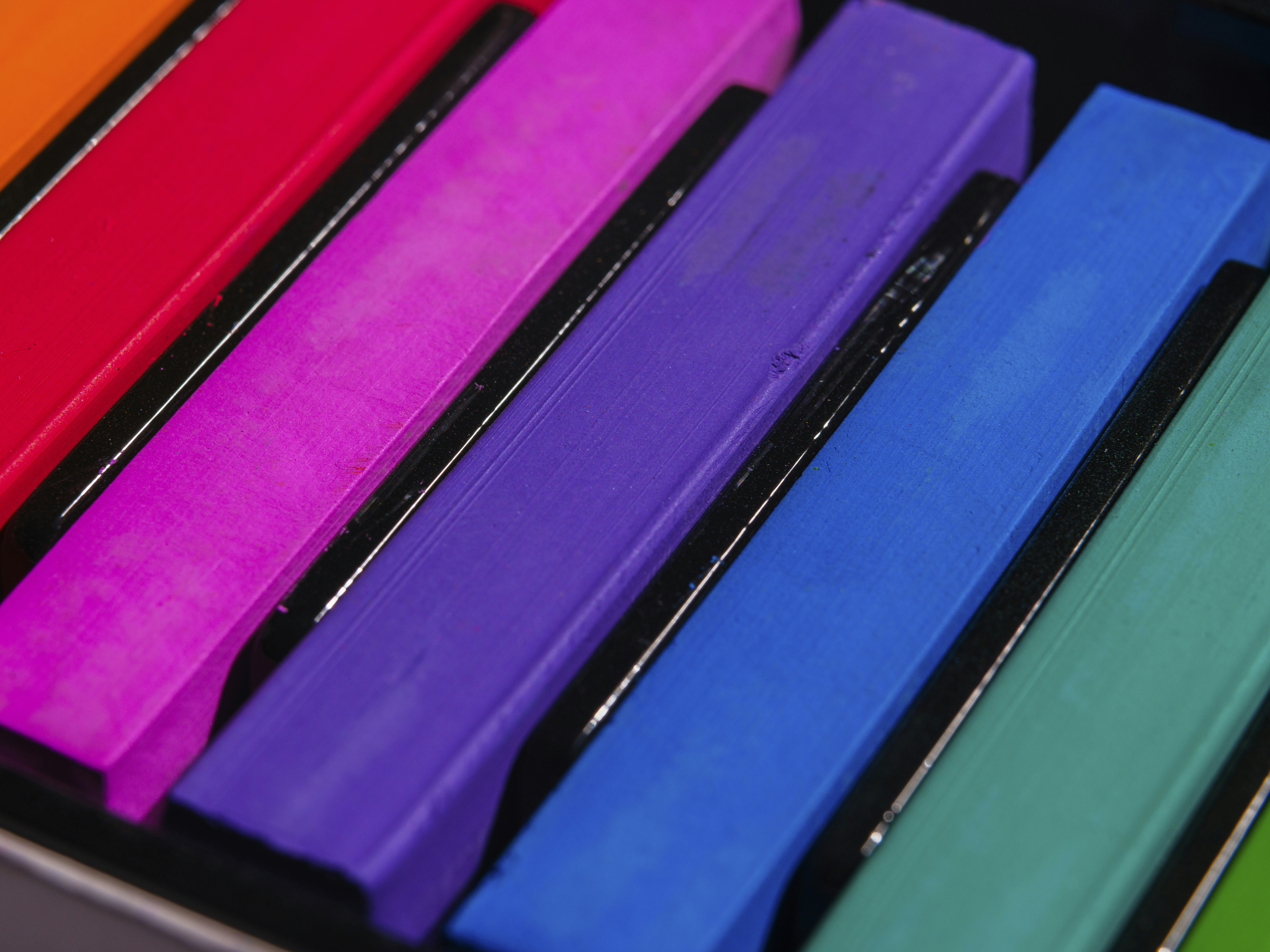 a row of brightly colored books sitting on top of a table