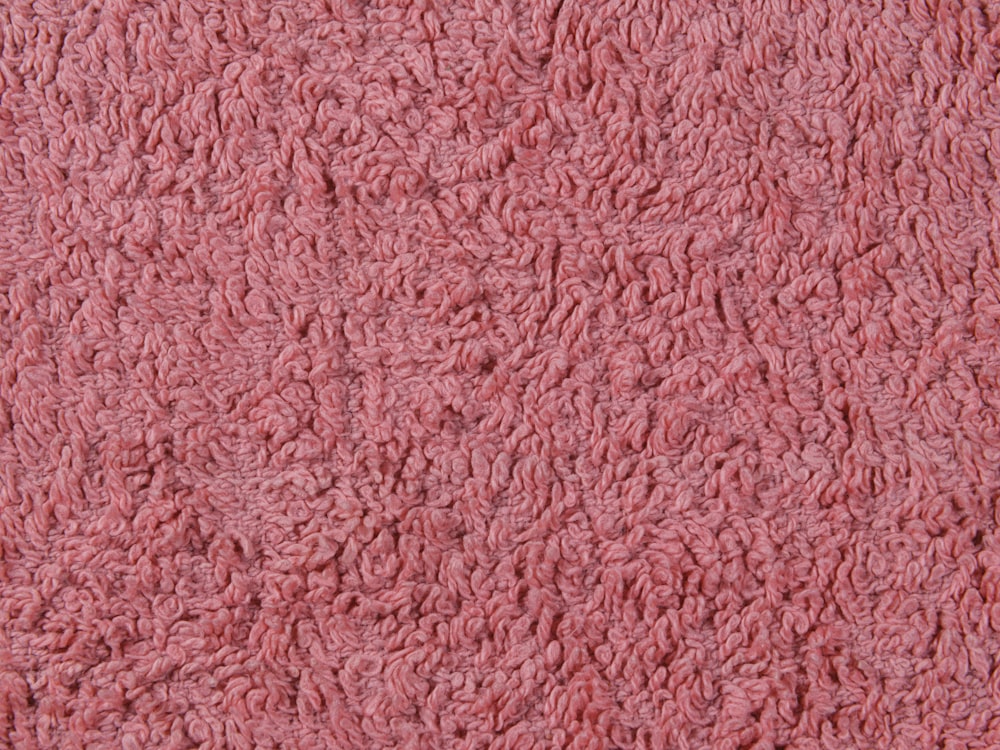 a close up of a pink area rug