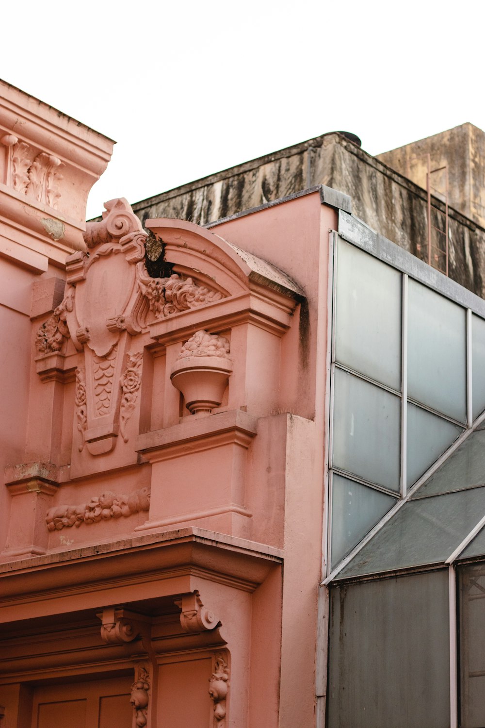 Un edificio rosa con un reloj en la parte superior