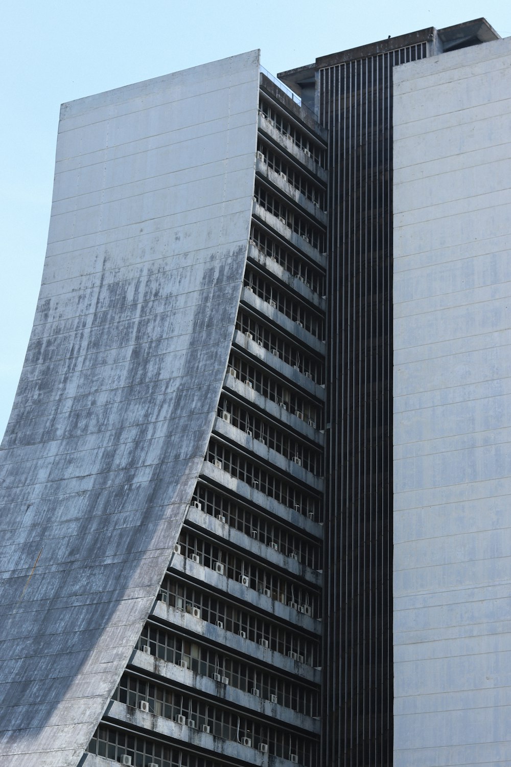 a very tall building with a curved roof