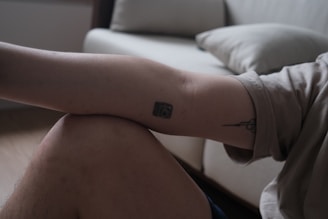 Before and after photos showing tattoo fading on an arm.