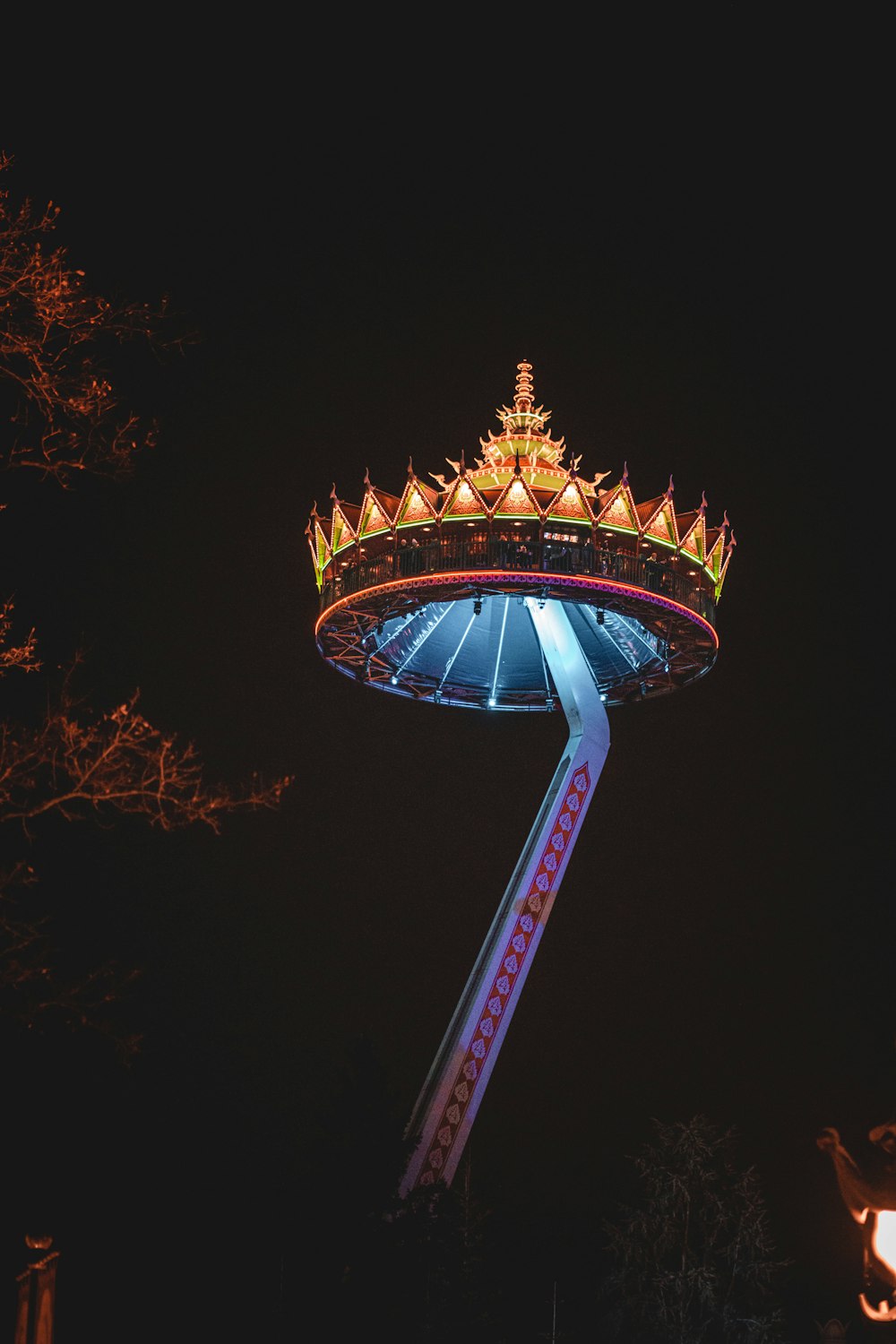 a carnival ride lit up at night in the dark