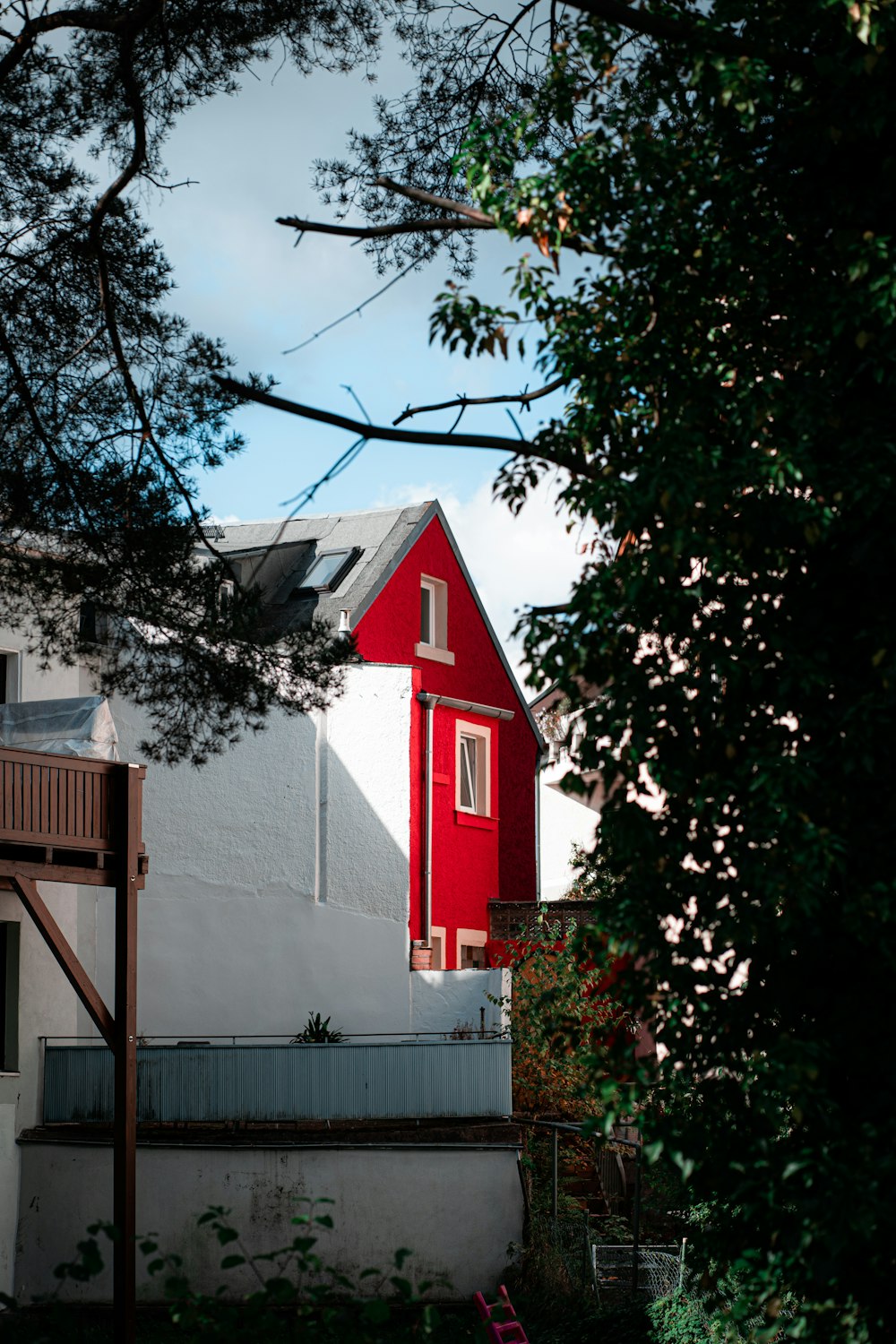 a house with a red roof and a red ladder
