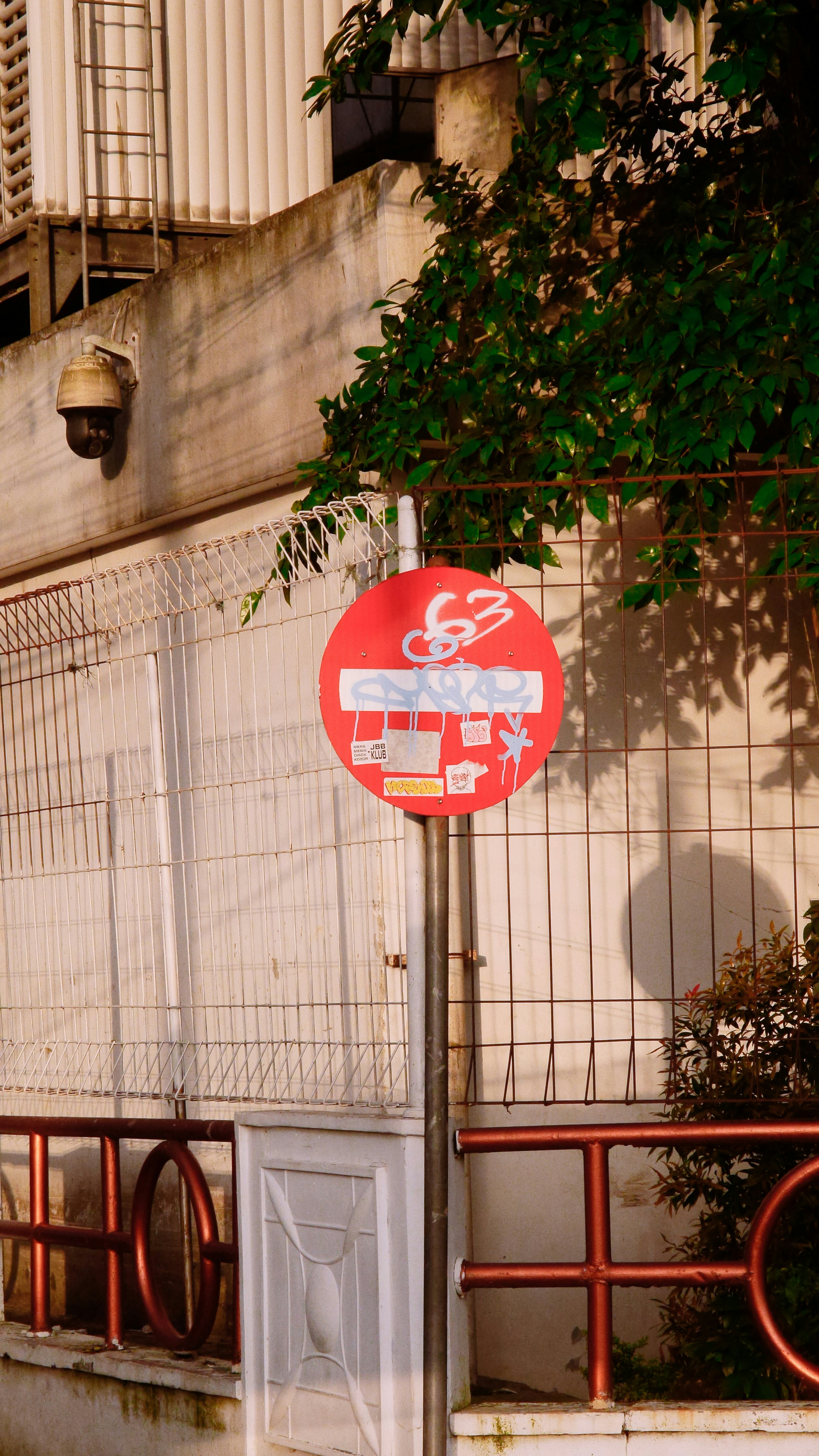 a red street sign sitting on the side of a road