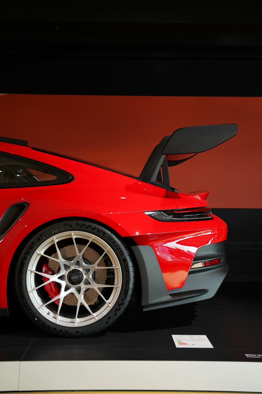 a red sports car on display at a car show