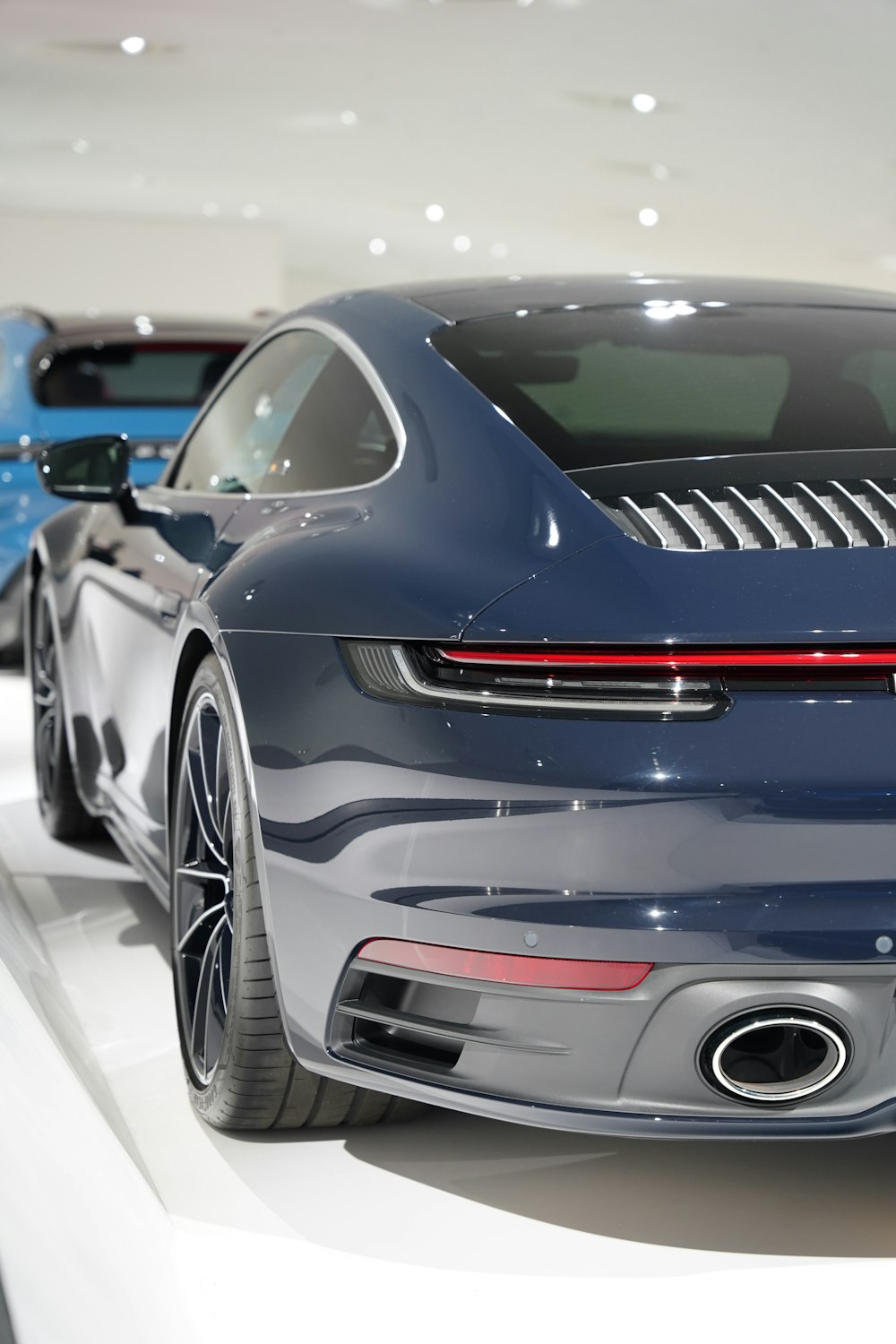 a blue sports car on display at a car show