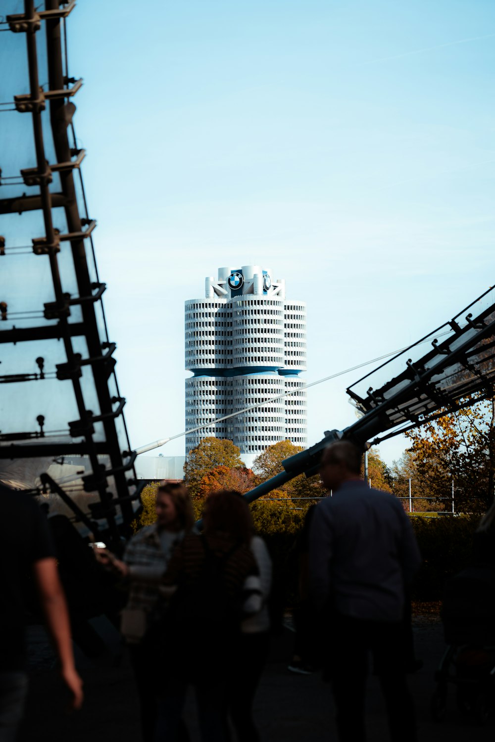 a group of people walking down a street next to a tall building