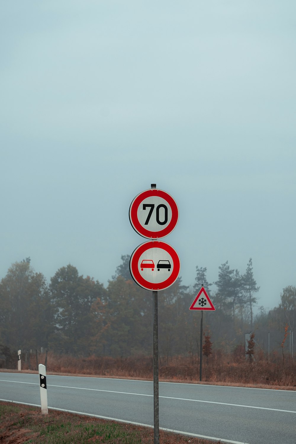 a couple of red and white signs sitting on the side of a road