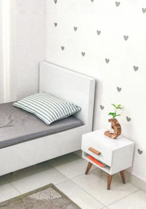 Stylish bedroom corner showcasing minimalist bed and decor.