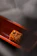 Close-up of a golden, crispy kibe on a rustic wooden plate with fresh herbs.