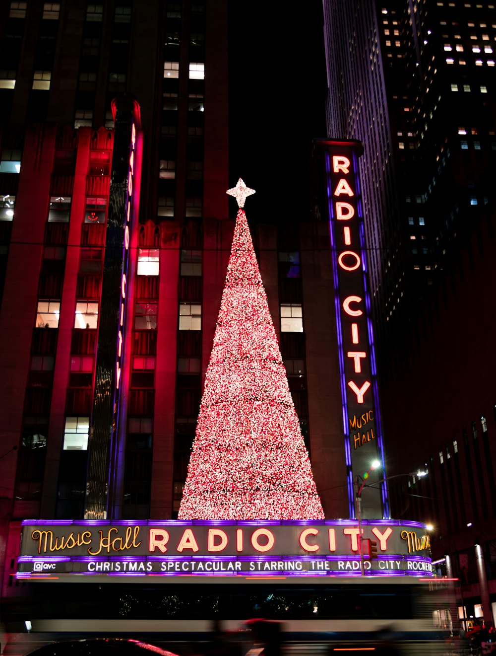a radio city christmas tree in front of radio city music hall
