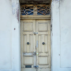 Before and after shots of a freshly maintained exterior door and frame.