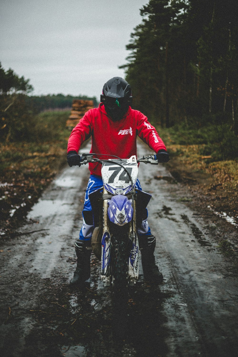 a person riding a dirt bike on a wet road