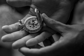 a person holding a watch in their hands
