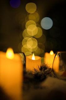 a group of lit candles sitting on top of a table