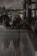 A group of people enjoying traditional music and food around a rustic wooden table.