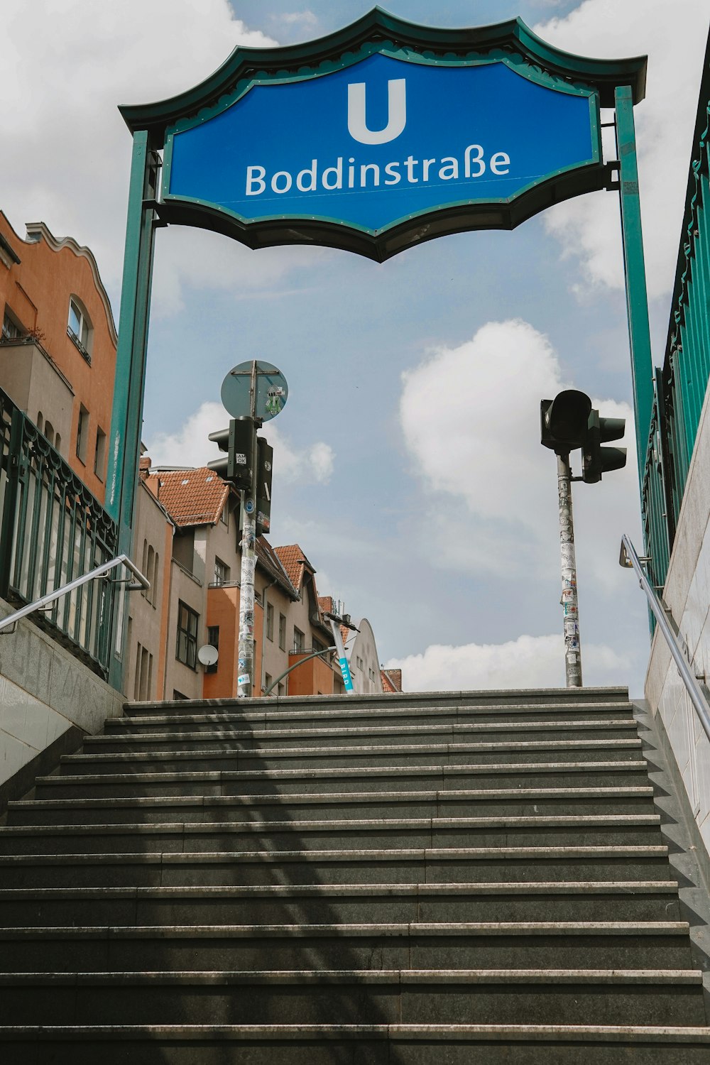 a stairway with a blue sign above it