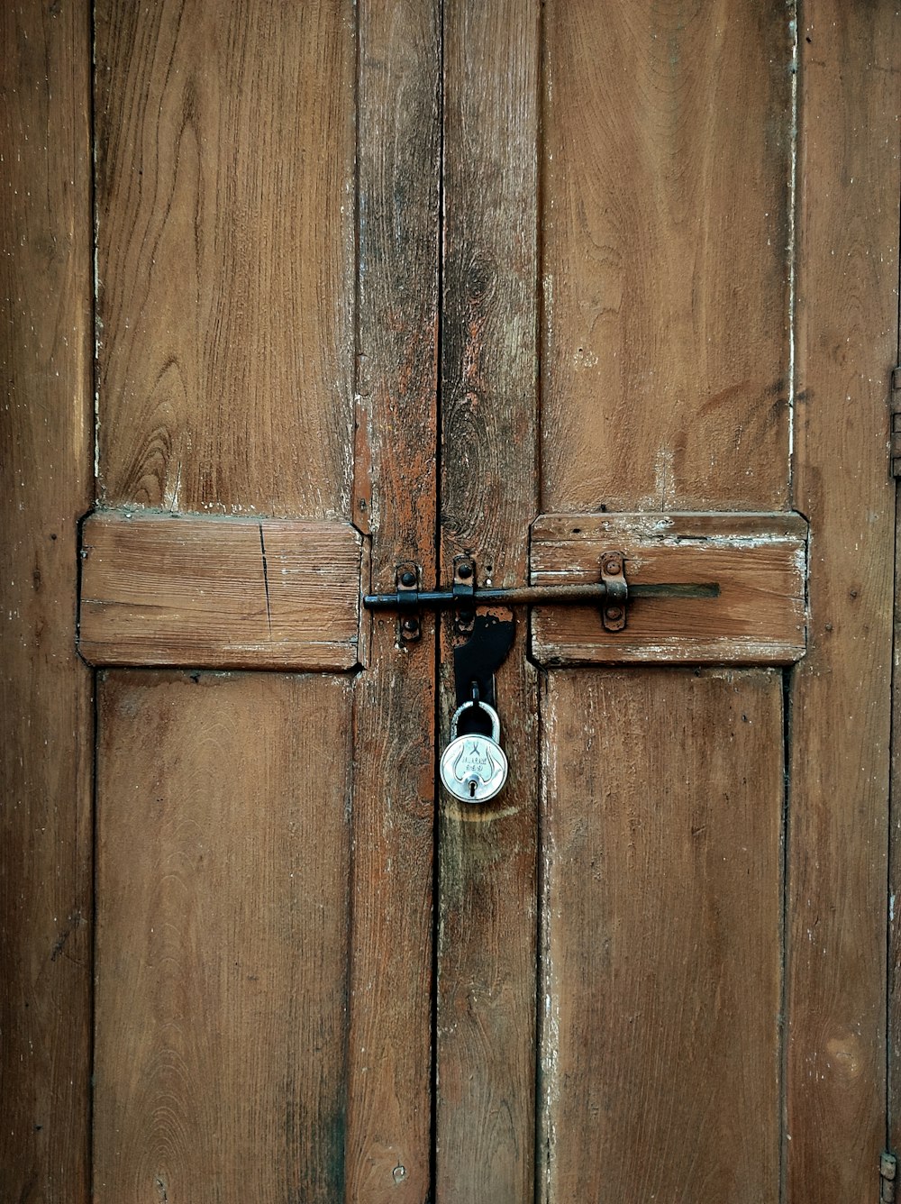 a wooden door with a clock on it