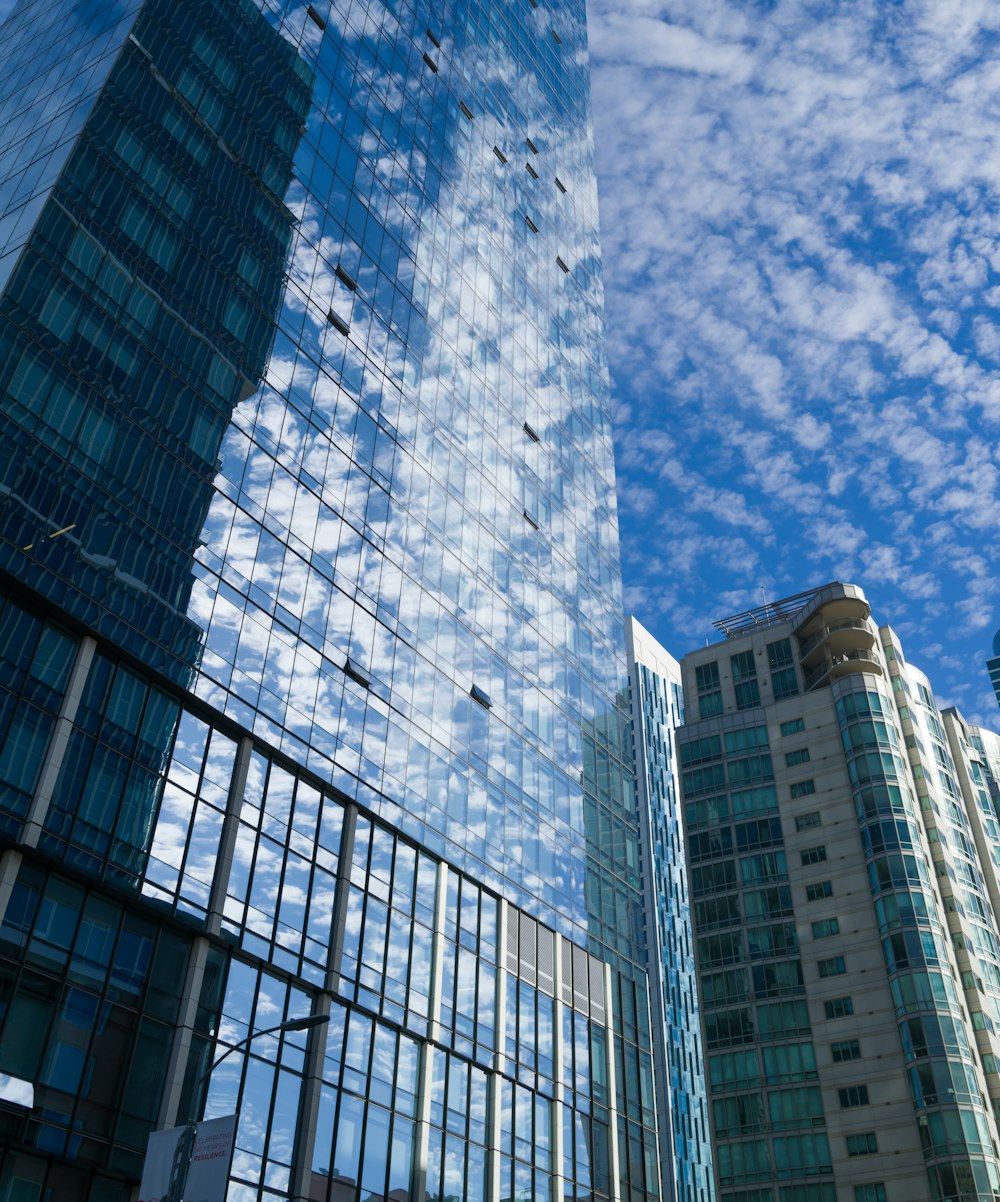 a couple of tall buildings sitting next to each other