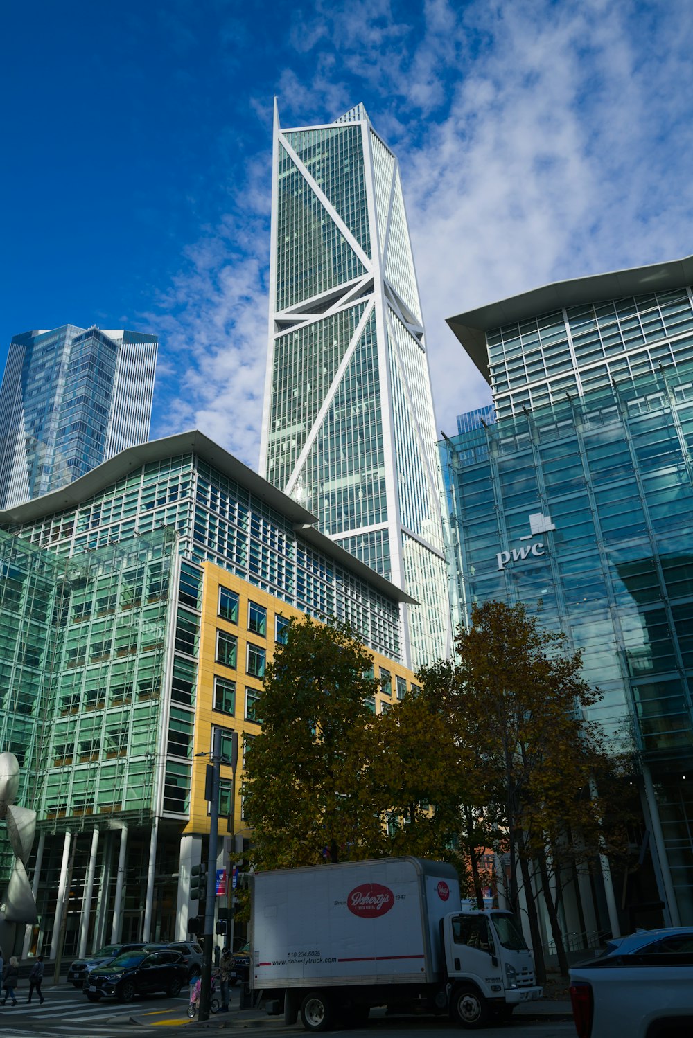 a truck is parked in front of some tall buildings