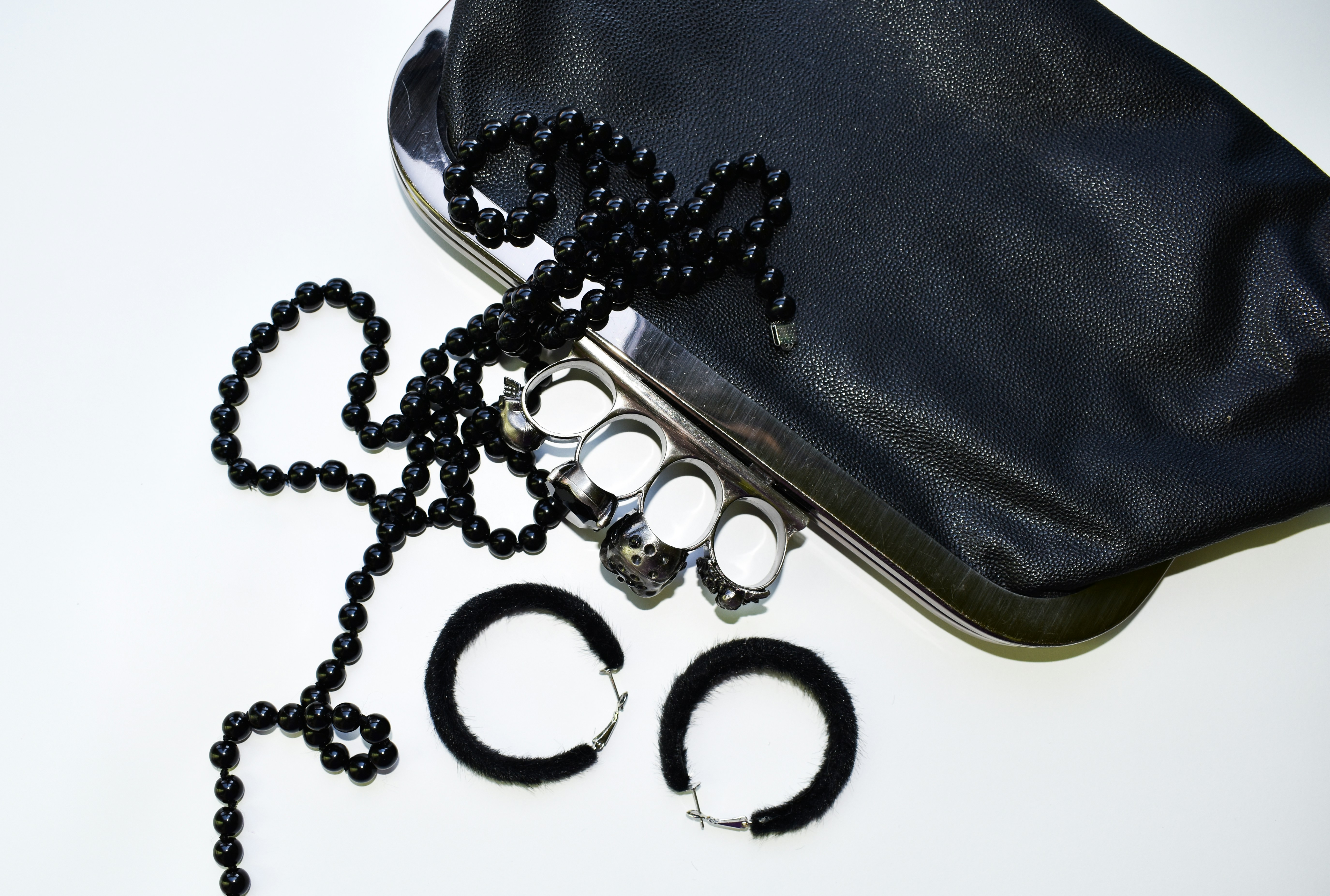 a pair of black beaded glasses and a black purse