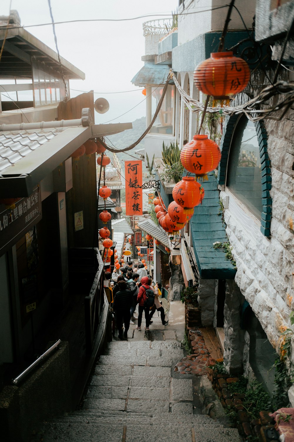 a group of people walking down a narrow street